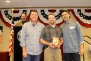 Nate Ferris receives the Under 50 Gold Glove from coaches Eric Rasmussen and Rick Aguilera.